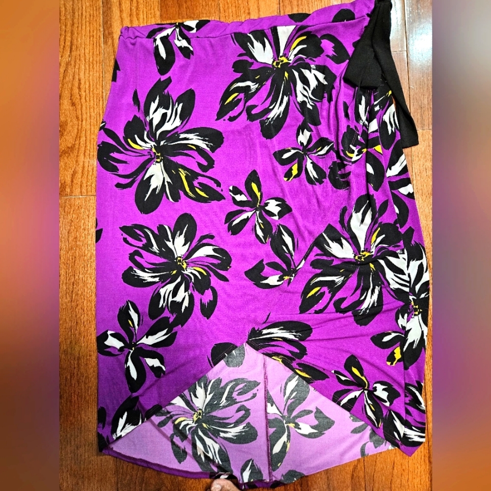 Purple, black, yellow and white floral plus size skirt with black bow on waist.